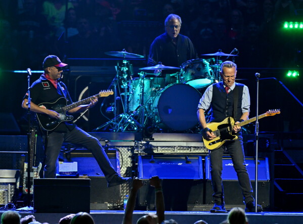 Tom Morello, from left, Max Weinberg and Bruce Springsteen perform during the 
