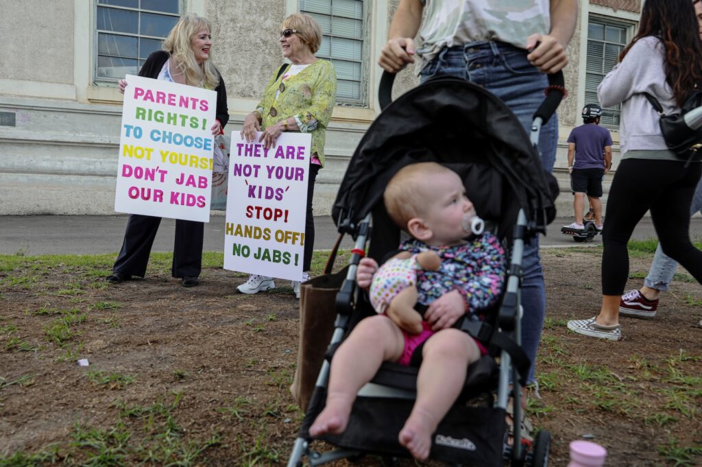 Anti-vaccine protesters stage a protest outside of the San Diego Unified School District office to protest a forced vaccination mandate for students  on September 28, 2021 in San Diego, California. The School District was holding a virtual hearing on whether to enact a mandate for students to recieve at least one dose of a COVID vaccine. ((Photo by Sandy Huffaker/Getty Images))