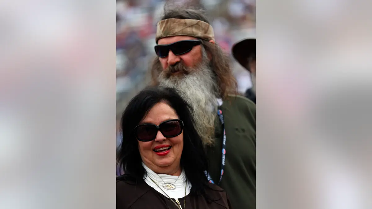 Phil Robertson and Kay Robertson standing at NASCAR pre-race ceremonies at Texas Motor Speedway