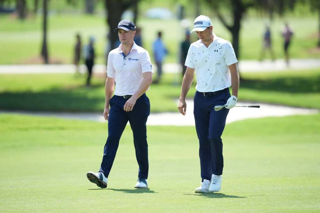 Jordan Spieth and Justin Thomas walk down the fairway during the first round of the Cadillac Championship