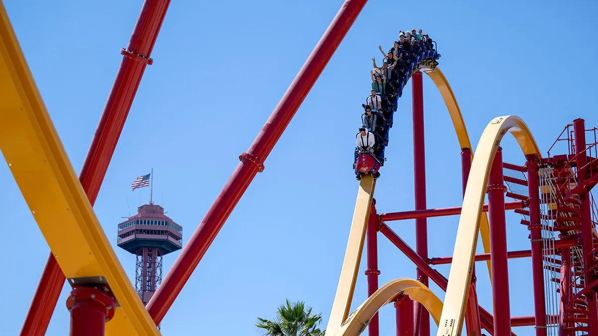 People riding Wonder Woman Flight of Courage roller coaster at Six Flags Magic Mountain in Valencia California