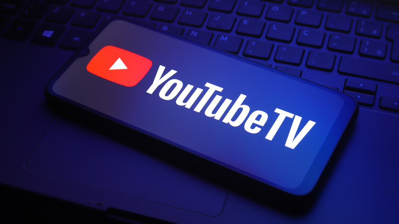 The YouTube TV logo on a smartphone with a blue tint