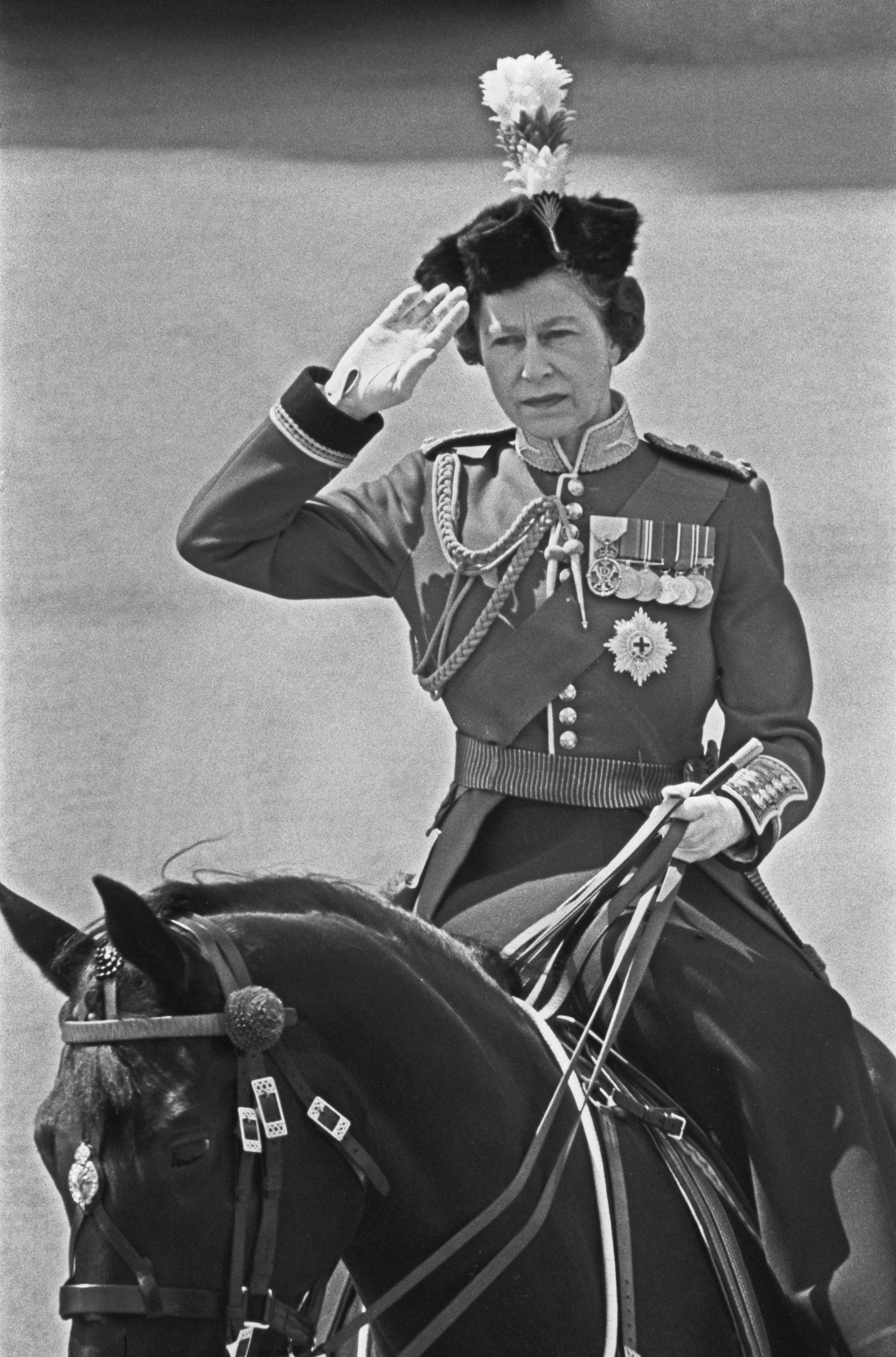 Queen Elizabeth riding a horse wearing a uniform at Trooping the Colour 1973