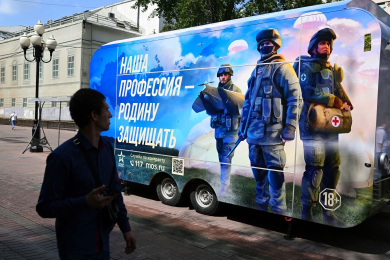 A man walks past a contract army service mobile recruitment point in Moscow on July 6, 2023.
