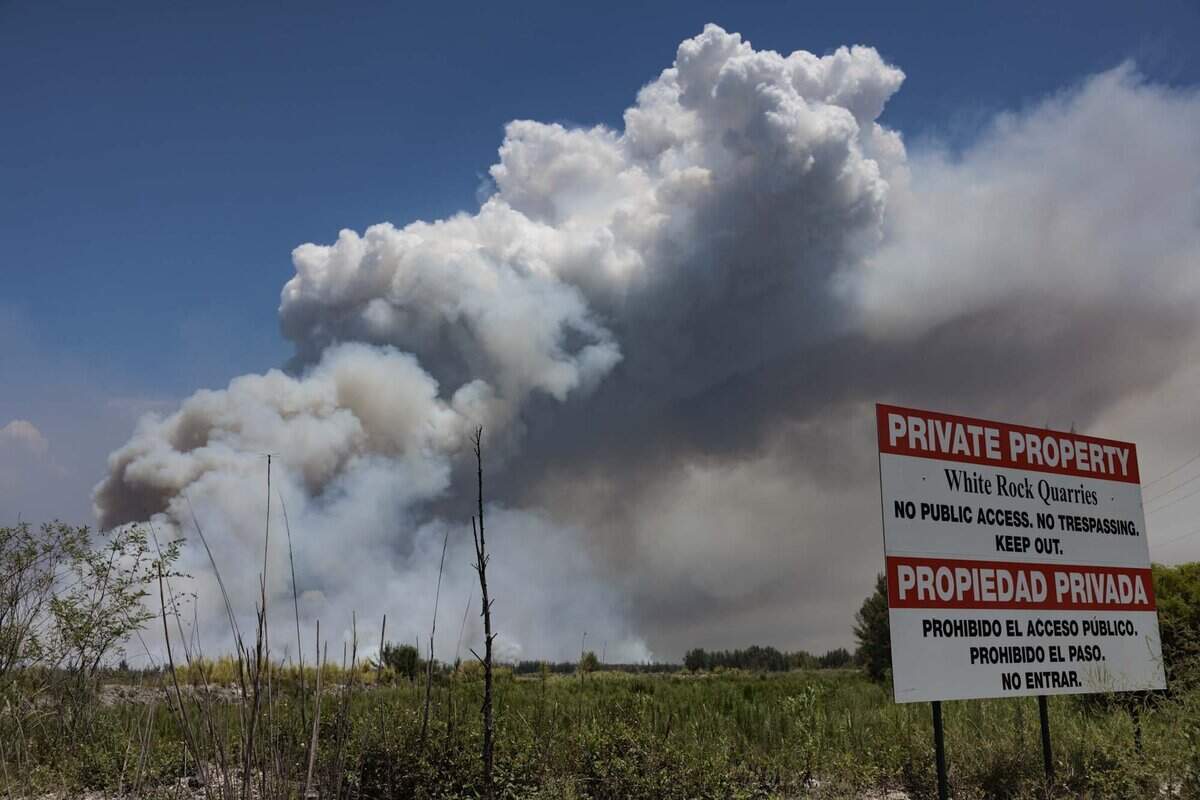 Smoke rises during a brush fire on Wednesday, June 17, 2026, in west Miami-Dade just west of Doral. The fire is 7,500 acres and 30% contained as of Wednesday afternoon.