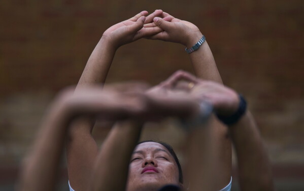People perform yoga on International Yoga Day in Lalitpur, Nepal, Sunday, June 21, 2026. (AP Photo/Niranjan Shrestha)