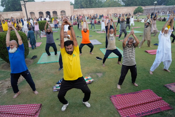 People practice yoga during a celebration of the International Yoga Day in Lahore, Pakistan, Sunday, Jun 21, 2026. (AP Photo/K.M. Chaudary)