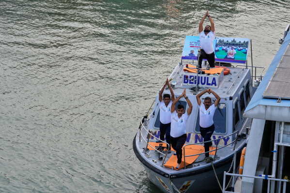 Indian Navy persons perform yoga on International Yoga Day on a Navy patrol boat on Hooghly River in Kolkata, India, Sunday, June 21, 2026. (AP Photo/Bikas Das)