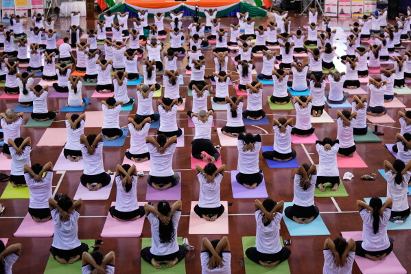 People take part in mass yoga programs to mark International Yoga Day organized by India Embassy Sunday, June 21, 2026, in Yangon, Myanmar. (AP Photo/Thein Zaw)