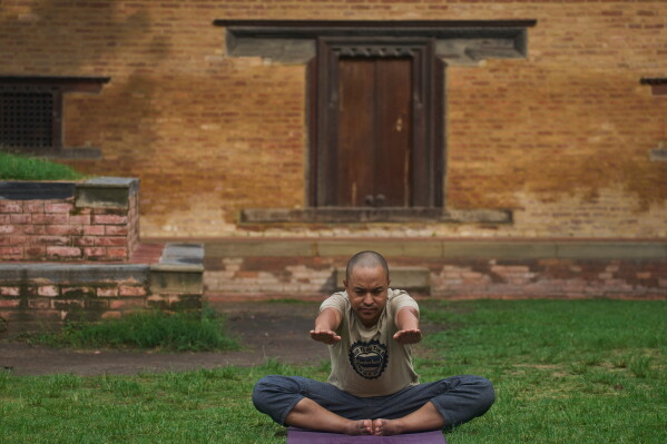 A man performs yoga on International Yoga Day in Lalitpur, Nepal, Sunday, June 21, 2026. (AP Photo/Niranjan Shrestha)