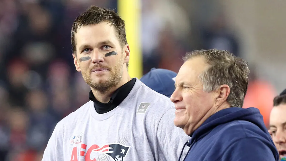 New England Patriots quarterback Tom Brady standing with head coach Bill Belichick at Gillette Stadium.