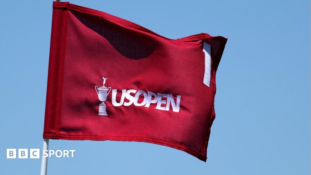 A red flag with an image of the US Open trophy, the words US Open and the number one on it, all in white.