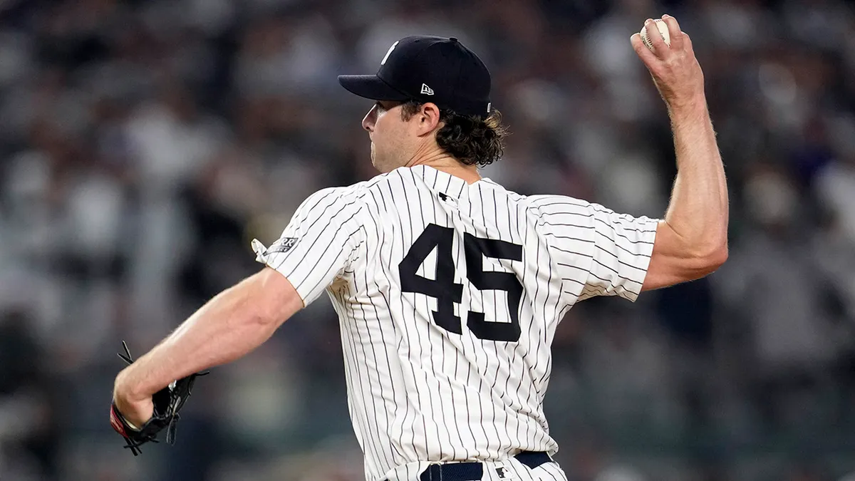 New York Yankees pitcher Gerrit Cole throwing a pitch during a baseball game.