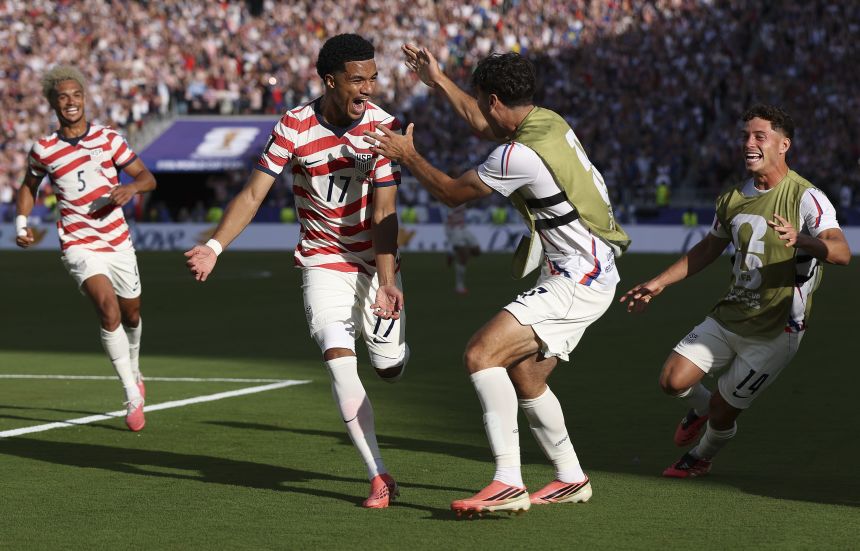 Malik Tillman, second from left, celebrates with his teammates after scoring a goal to put the United States up 2-0 in their World Cup match against Bosnia and Herzegovina on Wednesday, July 1. The Americans won by that score to advance to the Round of 16.