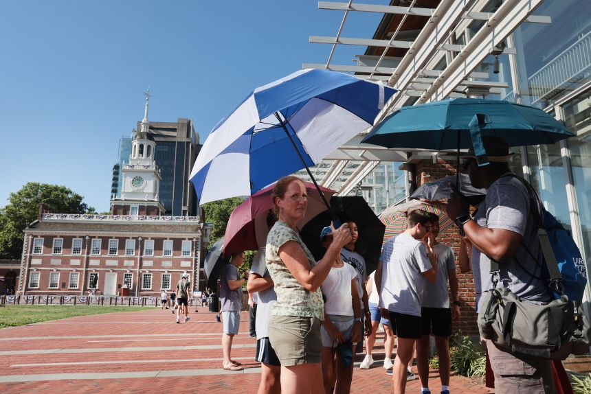 People gather outside of Independence Hall in Philadelphia during extreme heat on Friday, July 3.
