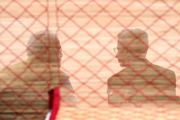 Indian Prime Minister Narendra Modi, left, and India’s foreign minister, Subrahmanyam Jaishankar, are seen behind a screen as they await the arrival of Japanese Prime Minister Sanae Takaichi for her ceremonial reception at the Presidential Palace in New Delhi, India, Thursday, July 2, 2026. (AP Photo/Manish Swarup)