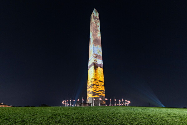 Images are projected onto the Washington Monument, Tuesday, June 30, 2026, in Washington. (AP Photo/Jen Golbeck)