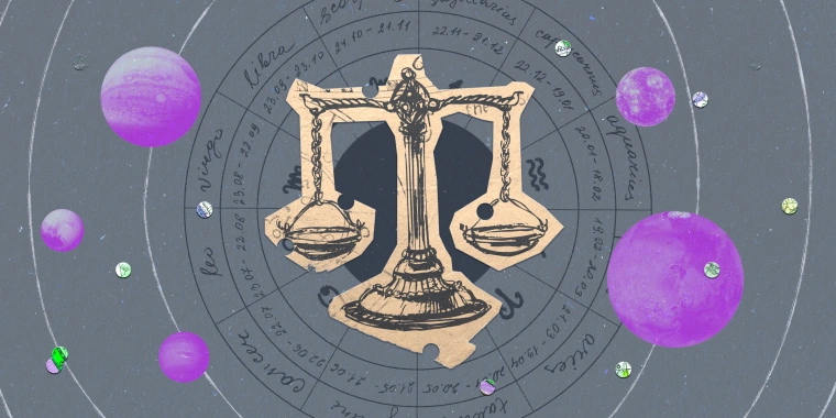 Paper cutout of the libra zodiac on a gray background
