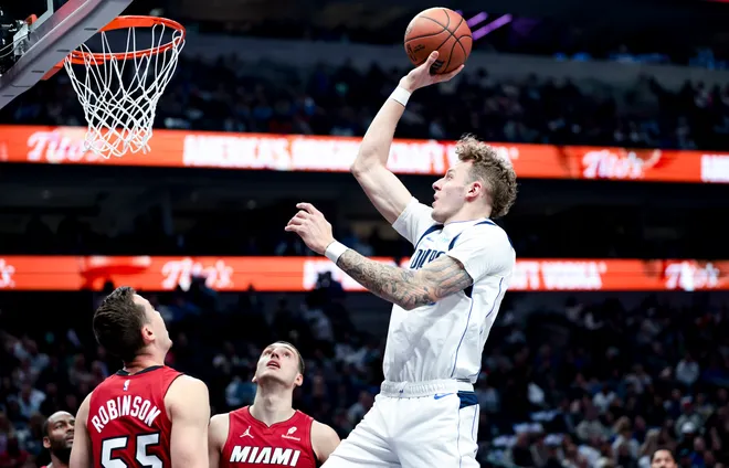 Feb 13, 2025; Dallas, Texas, USA; Dallas Mavericks center Kylor Kelley (50) shoots over Miami Heat forward Duncan Robinson (55) during the first half at American Airlines Center. Mandatory Credit: Kevin Jairaj-Imagn Images