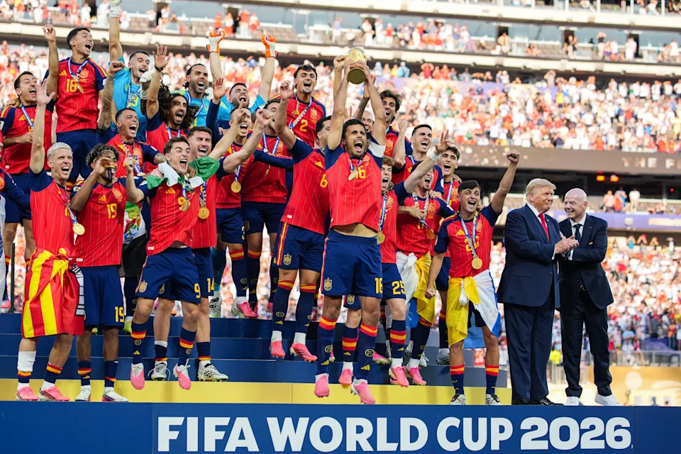 Soccer team celebrates winning FIFA World Cup 2026, holding the trophy on a podium, surrounded by cheering fans and officials