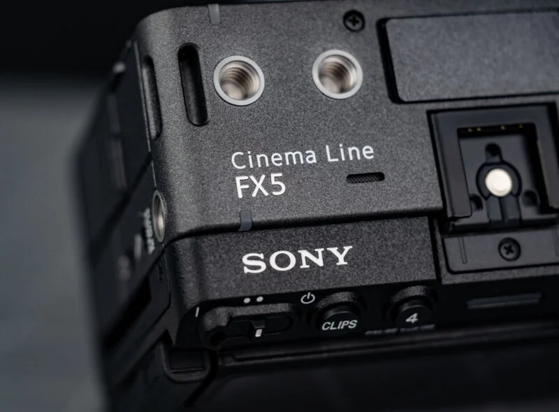 Close-up of a black Sony Cinema Line FX5 camera body, showing the brand name, model label, and part of its input ports and controls.