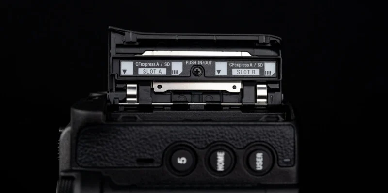 Close-up of a camera's dual memory card slots labeled 