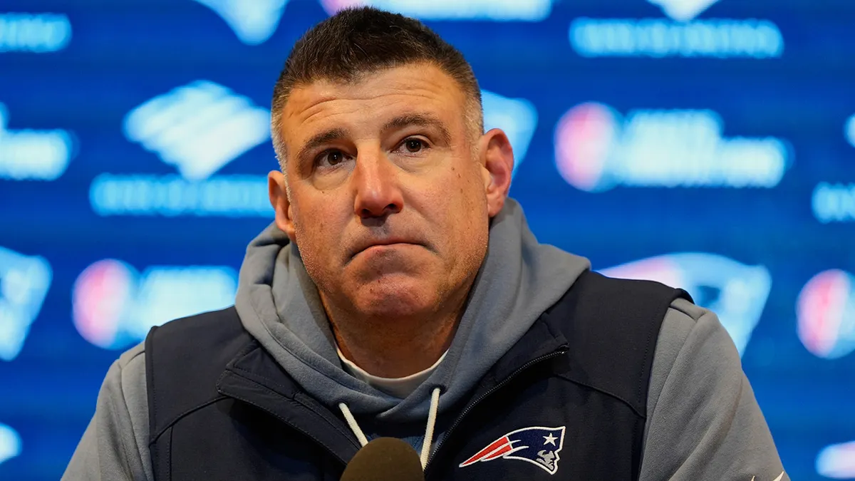 Mike Vrabel talks to reporters