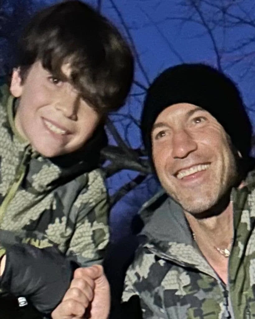 Jon Bernthal and his son Henry smiling wearing camo clothes