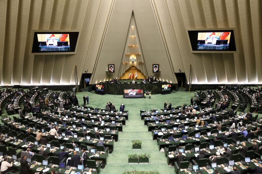 Iranian parliament members attend a parliament meeting in Tehran on September 28, 2025.