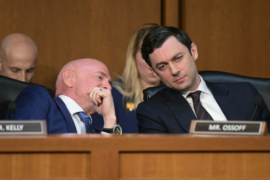 US Sen. Mark Kelly, a Democrat from Arizona, speaks with Sen. Jon Ossoff, a Democrat of Georgia, during a Senate Committee on Intelligence hearing to examine worldwide threats, on Capitol Hill in Washington, DC, on March 18, 2026.