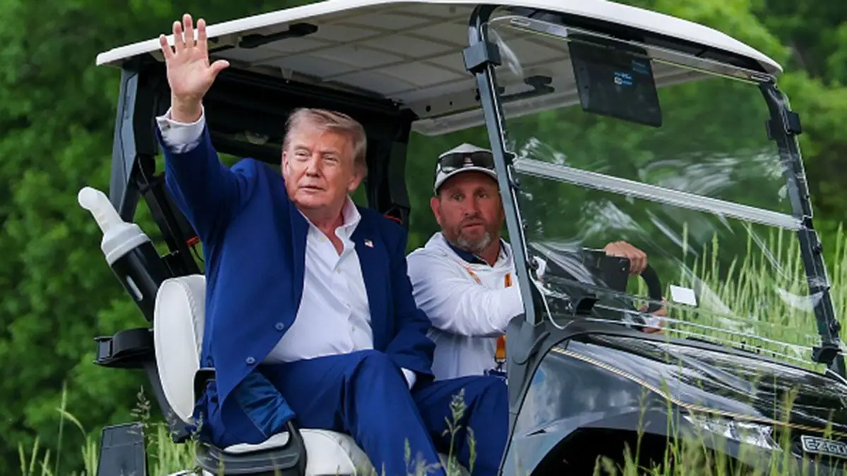 Donald Trump departs via golf cart at Trump National Golf Club during LIV Golf Virginia.