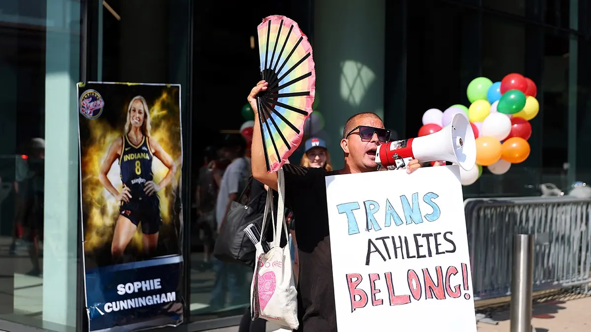 Demonstrator protests outside Target Center before a WNBA game between the Indiana Fever and Minnesota Lynx in Minneapolis.