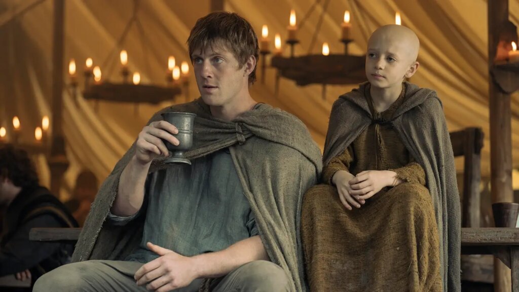 Viserys Targaryen (Paddy Considine) and young Rhaenyra (Milly Alcock) stand before the skull of Balerion the Black Dread.