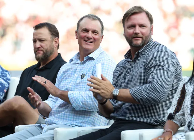 Former White Sox players, from left, Mark Buehrle, Paul Konerko and A.J. Pierzynski look on as former Sox shortstop and manager Ozzie Guillen speaks during his jersey retirement ceremony before a game against the Guardians on Saturday, Aug. 8, 2026, at Rate Field. (Chris Sweda/Chicago Tribune)