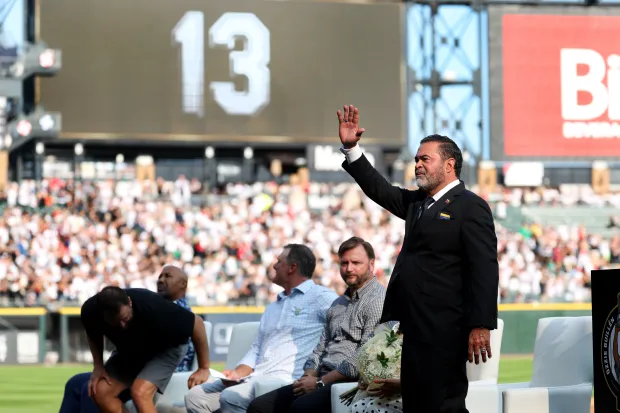 Former White Sox shortstop and manager Ozzie Guillén acknowledges the crowd during his jersey retirement ceremony before a game against the Guardians on Saturday, Aug. 8, 2026, at Rate Field. (Chris Sweda/Chicago Tribune)