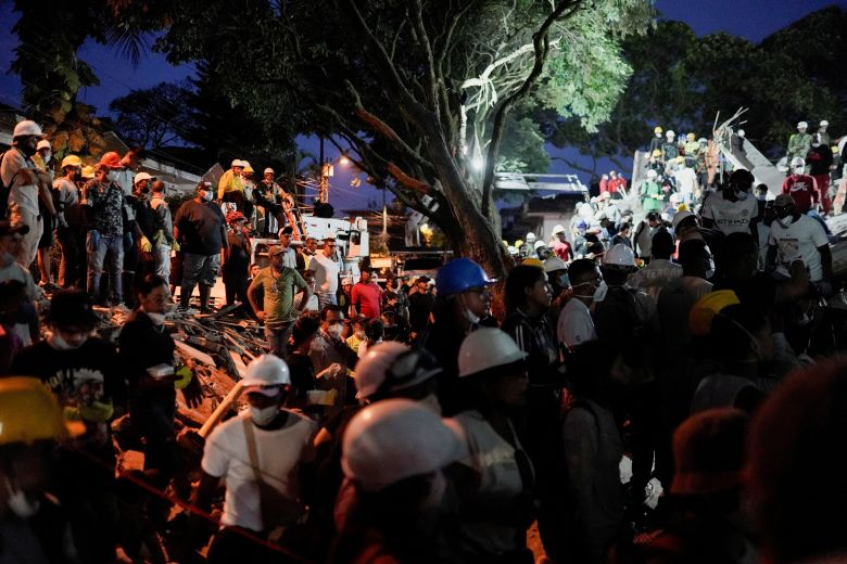 People wait for the rescue of survivors at La Torres del Limonar building in the aftermath of an earthquake, in Cali, Colombia, August 11, 2026.