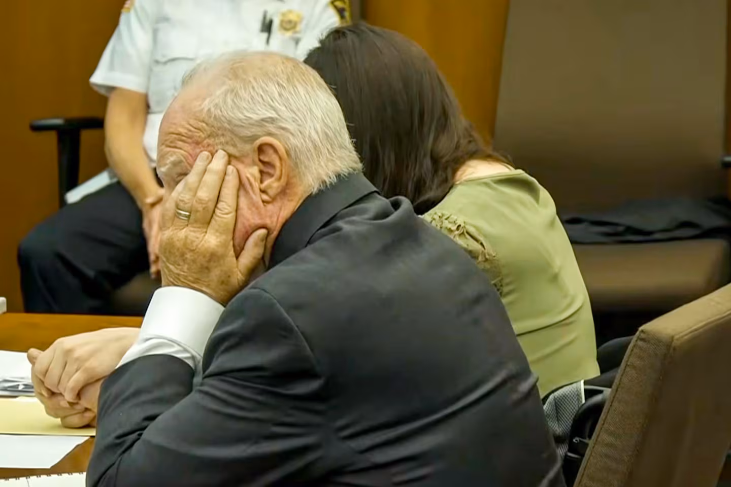 Kevin Reddington holds Lindsay Clancy's hand as she cries as Nichole Bradley, a deputy superintendent with the Plymouth County Sheriff's Office testifies.