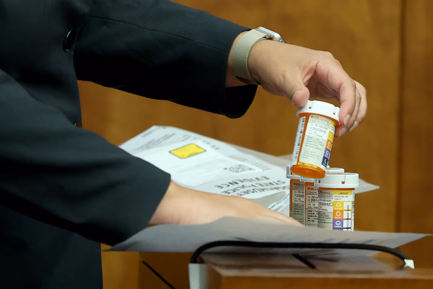 Prosecutor Shanan Buckingham presents prescription medication as evidence during Lindsay Clancy's murder trial at Plymouth Superior Court in Plymouth, Mass., Wednesday, Aug. 12, 2026.