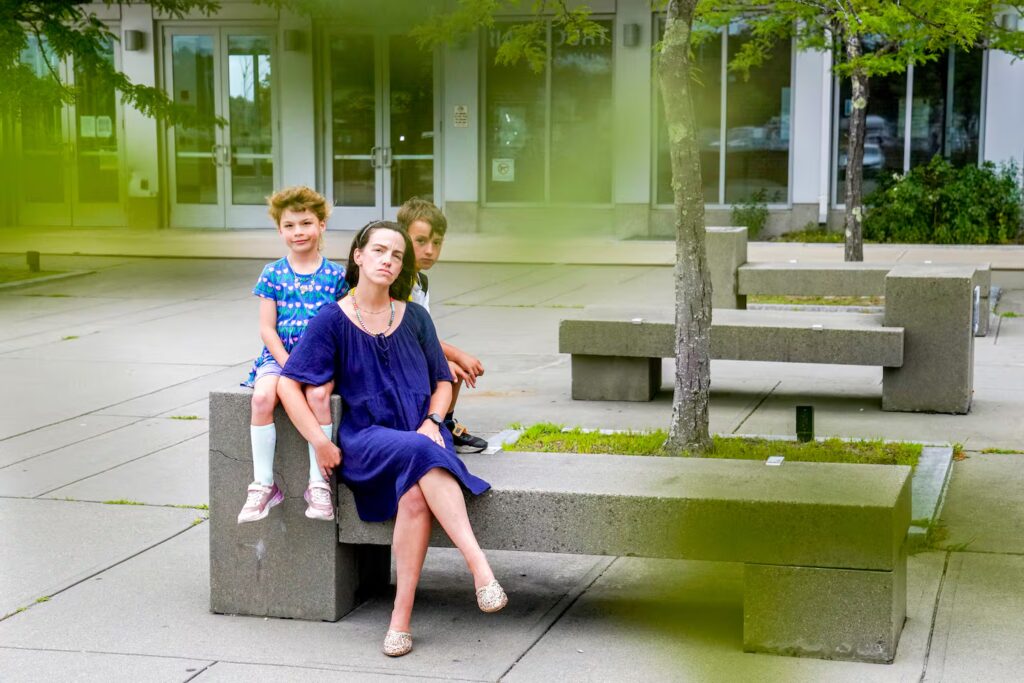 Sarah Baroud, a perinatal clinical social worker, therapist, and mental health advocate,  sits outside the Plymouth courthouse with her children.