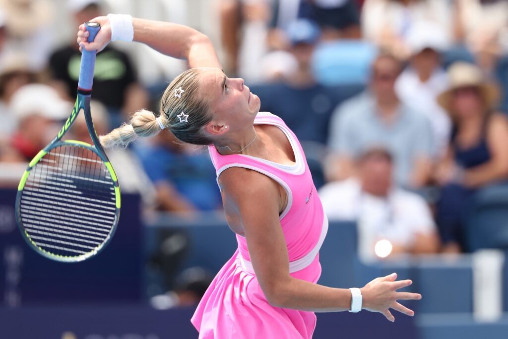 Sara Bejlek jumps to hit a tennis ball