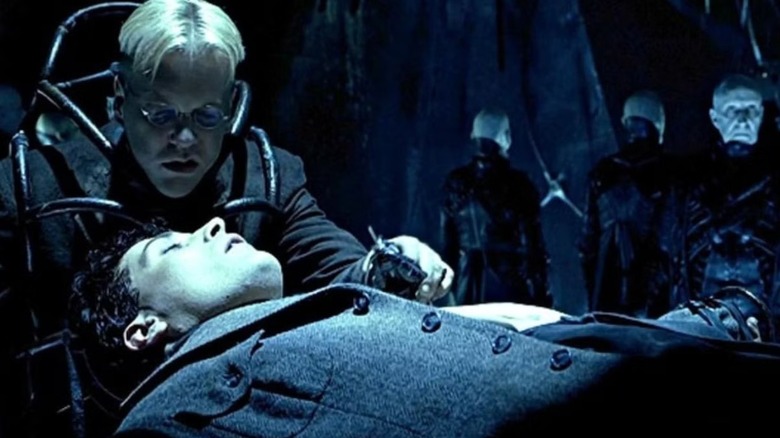 Dr. Daniel P. Schreber (Kiefer Sutherland) leaning over John (Rufus Sewell) in