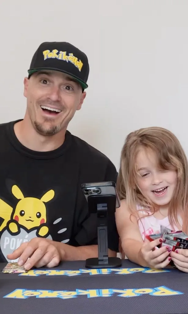 Los Angeles Dodgers superutility player Kiké Hernández (left) opens up a pack of Pokémon cards with his 5-year-old daughter Penélope.