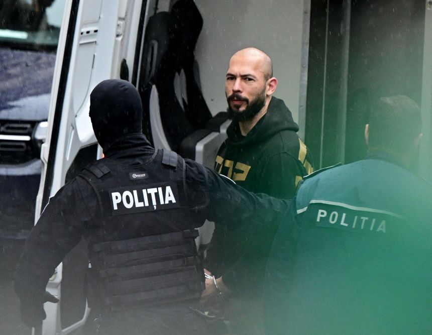 Andrew Tate is led by police officers to the Court of Appeal in Bucharest in March 2024.