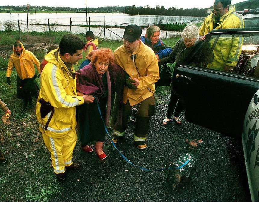 Red Halem, center, is evacuated from her home in Petaluma, California on February 19, 1998. A powerful, El Niño-driven storm brought wild winds and driving rain that pushed streams over their banks and left the threat of landslides hovering above scores of homes.