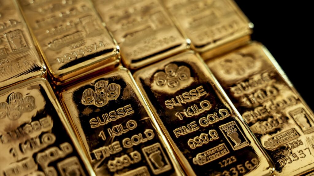 Gold pulls back after two-month high as oil, hawkish Fed outlook weigh