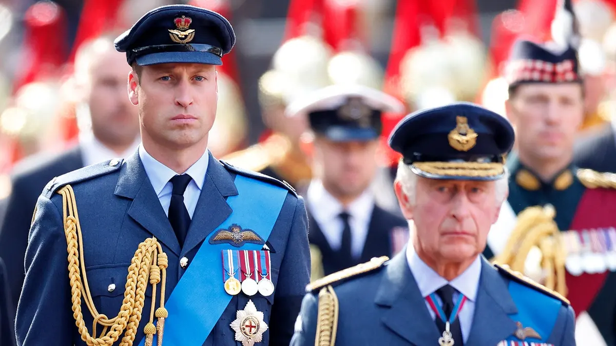 Prince William and King Charles III walk behind Queen Elizabeth II's coffin during a procession in London.