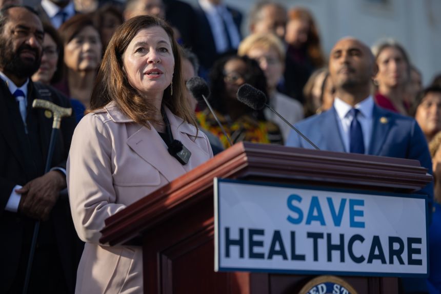 Rep. Kristen McDonald Rivet of Michigan speaks at a press conference on healthcare with other members of the House Democratic caucus ahead of votes on government funding, in front of the US Capitol in Washington, DC, on November 12, 2025.
