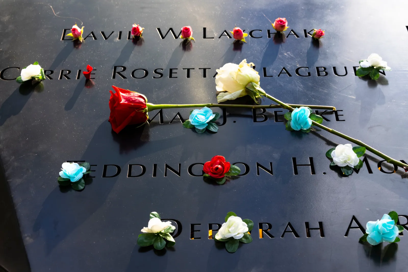 File image: Flowers adorn the names of the victims of the attacks of Sept. 11, 2001, during a ceremony at the 9/11 Memorial and Museum on September 11, 2021 in New York City.