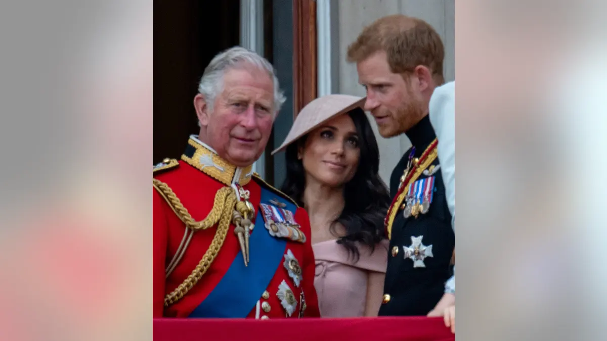 Prince Charles, Prince of Wales stands with Prince Harry, Duke of Sussex and Meghan, Duchess of Sussex.