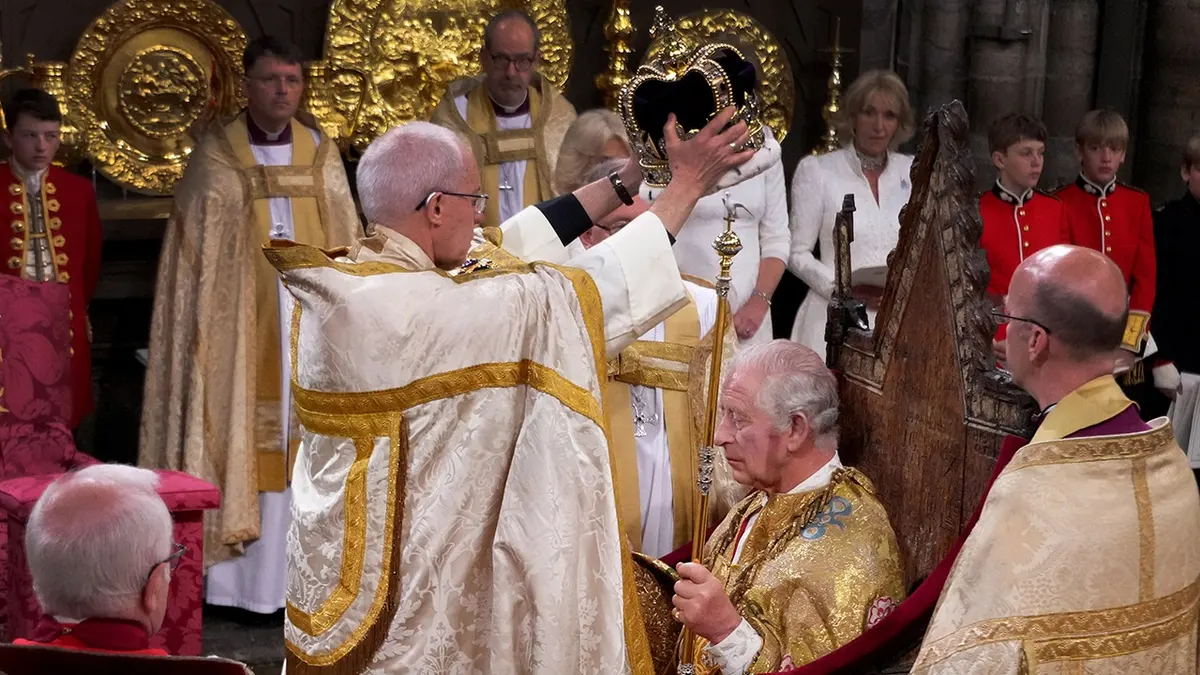 King Charles III is crowned with St. Edward's Crown by Archbishop Justin Welby at Westminster Abbey.